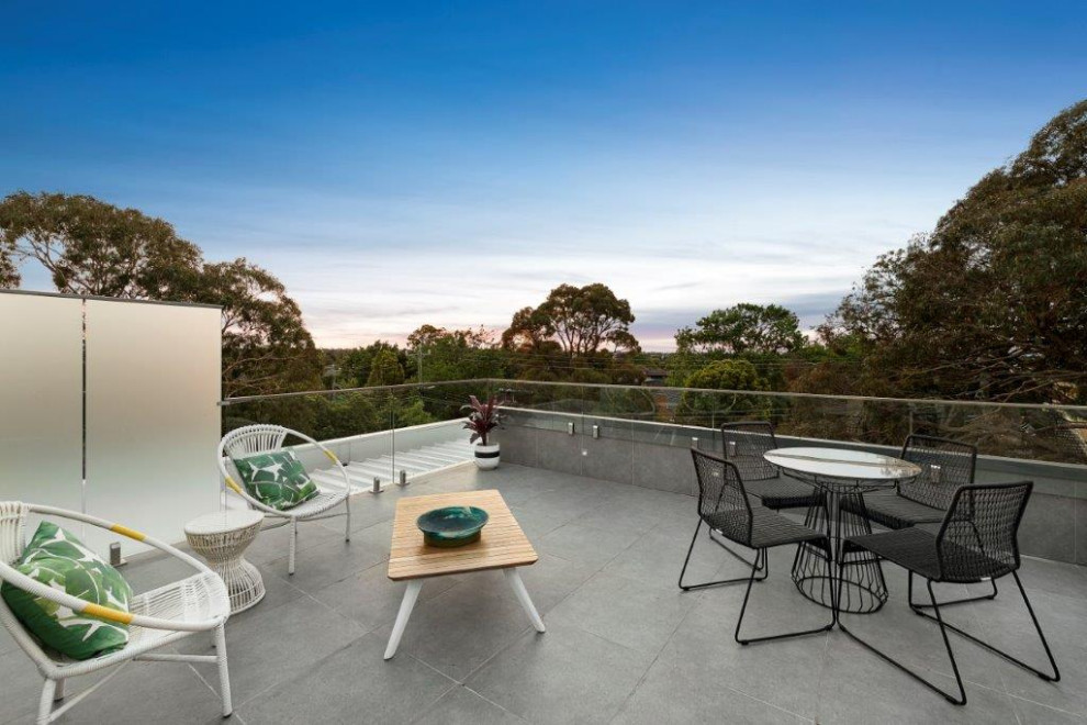 This is an example of a large contemporary balcony in Melbourne with no cover.