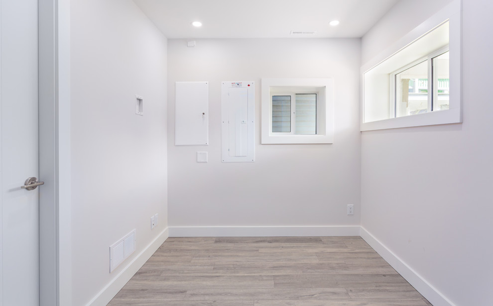 Basement - small transitional vinyl floor and gray floor basement idea in Vancouver with gray walls and no fireplace