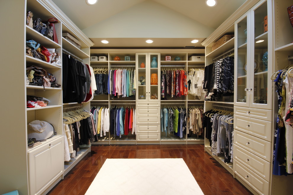 Inspiration for a large traditional gender-neutral walk-in wardrobe in Other with raised-panel cabinets, white cabinets and dark hardwood floors.