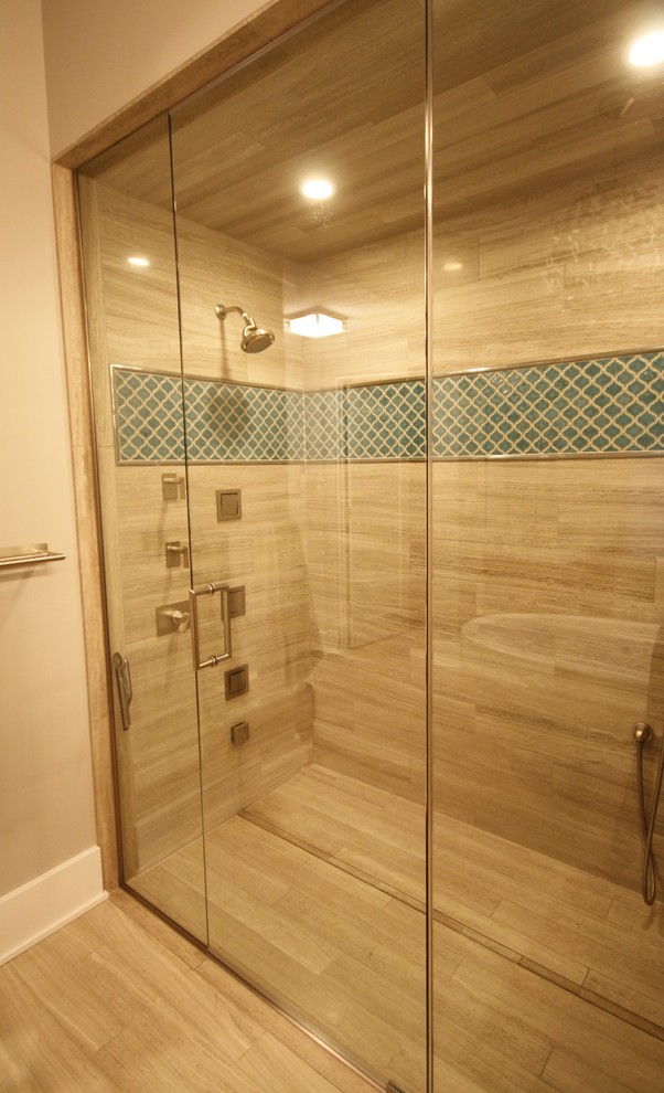 Design ideas for a mid-sized contemporary master bathroom in Chicago with flat-panel cabinets, dark wood cabinets, a freestanding tub, an alcove shower, blue tile, brown tile, porcelain tile, beige walls, light hardwood floors, an undermount sink, marble benchtops, beige floor, a hinged shower door and multi-coloured benchtops.