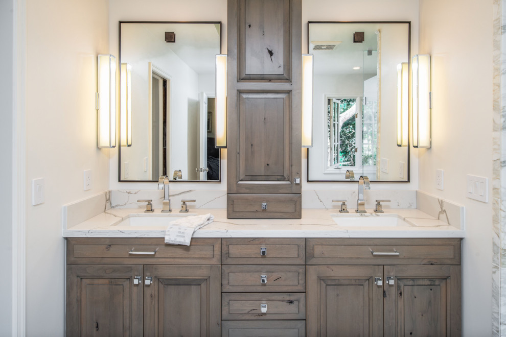 Inspiration for a transitional master bathroom in San Francisco with raised-panel cabinets, medium wood cabinets, a freestanding tub, a curbless shower, white tile, marble, white walls, marble floors, an undermount sink, engineered quartz benchtops, white floor, a hinged shower door and white benchtops.
