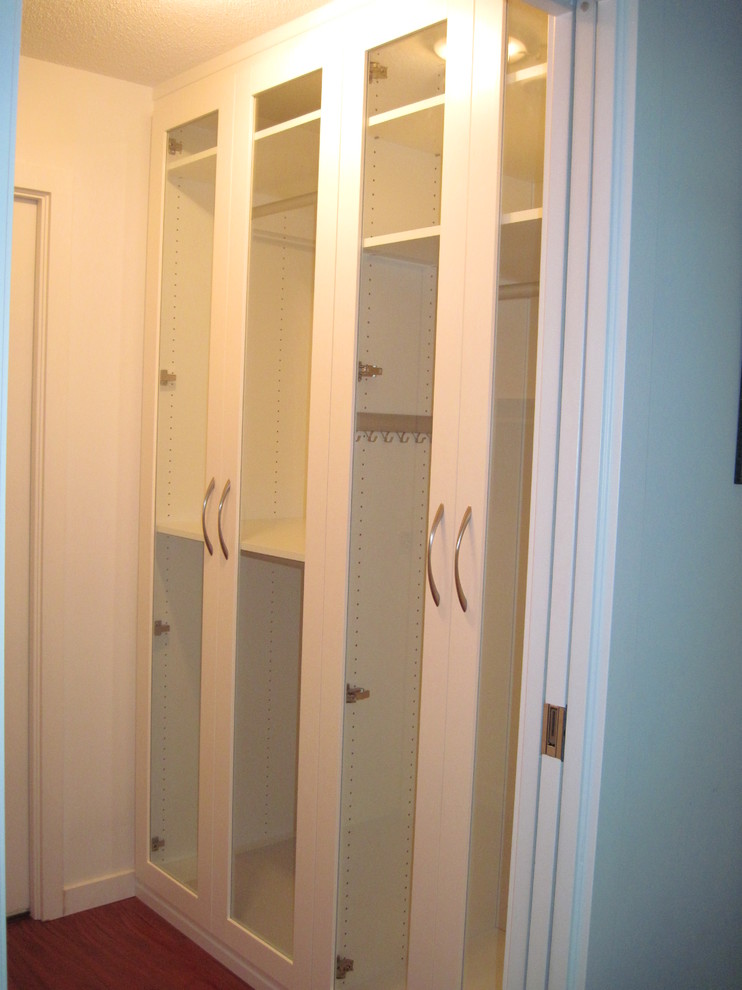 Example of a small trendy women's walk-in closet design in Other with shaker cabinets and white cabinets