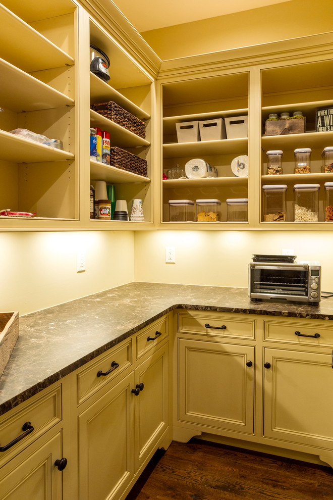 Photo of a mid-sized transitional l-shaped kitchen pantry in Charlotte with recessed-panel cabinets, beige cabinets, granite benchtops, stainless steel appliances, medium hardwood floors and no island.