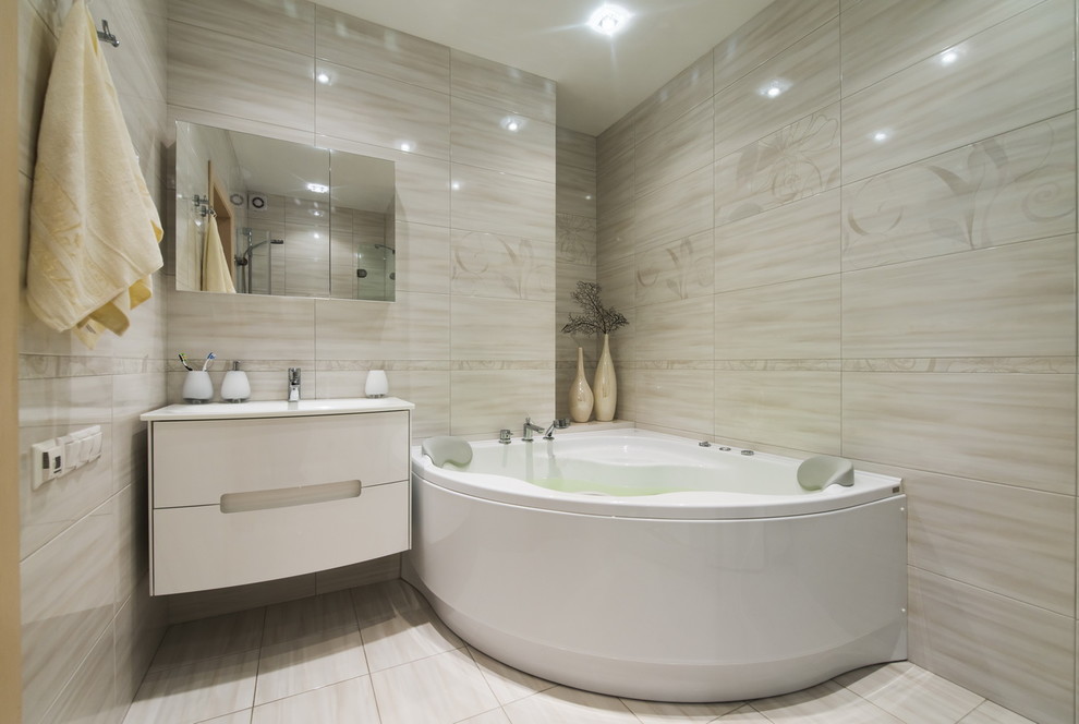 Mid-sized contemporary master bathroom in Malaga with furniture-like cabinets, beige cabinets, a drop-in tub, a double shower, beige tile, ceramic tile, beige walls, ceramic floors, a console sink, tile benchtops, beige floor and a hinged shower door.
