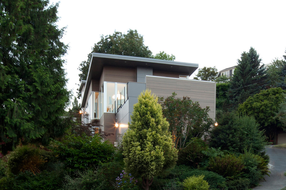 Contemporary split-level grey exterior in Seattle with mixed siding.