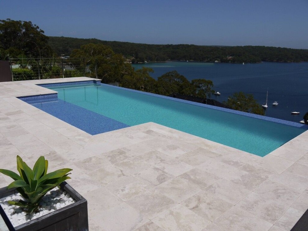 Inspiration for a large contemporary backyard rectangular infinity pool in Sydney.