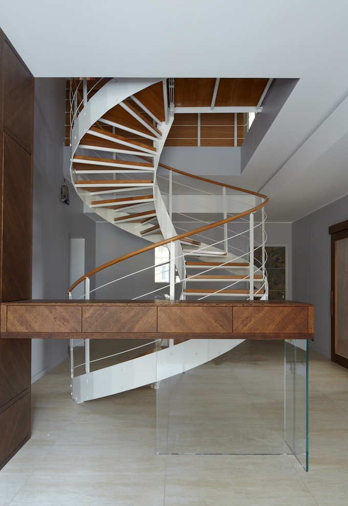 Inspiration for a mid-sized contemporary wood spiral staircase in Moscow with open risers.