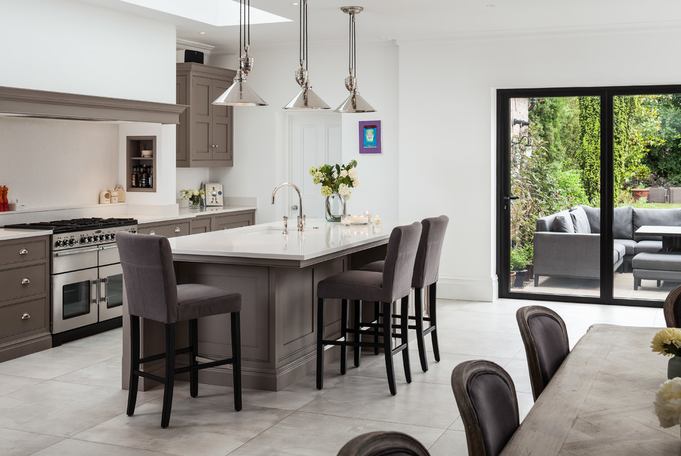 Inspiration for a mid-sized transitional single-wall eat-in kitchen in Surrey with an undermount sink, shaker cabinets, grey cabinets, stainless steel appliances, with island, grey floor and white benchtop.