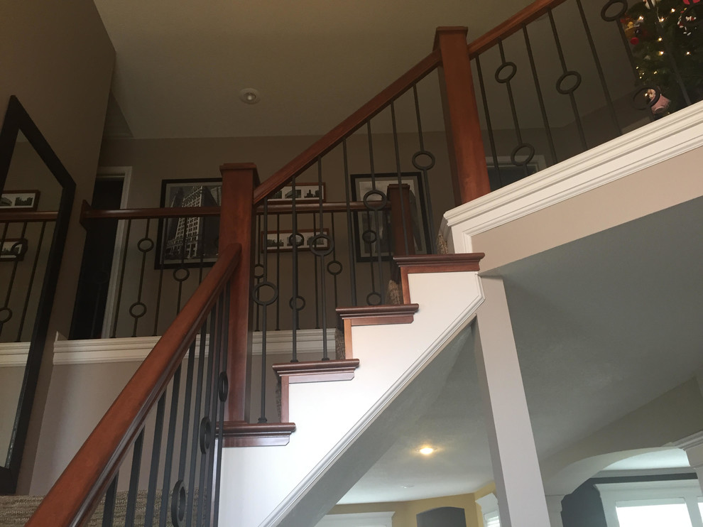This is an example of a traditional wood staircase in Kansas City with wood risers.