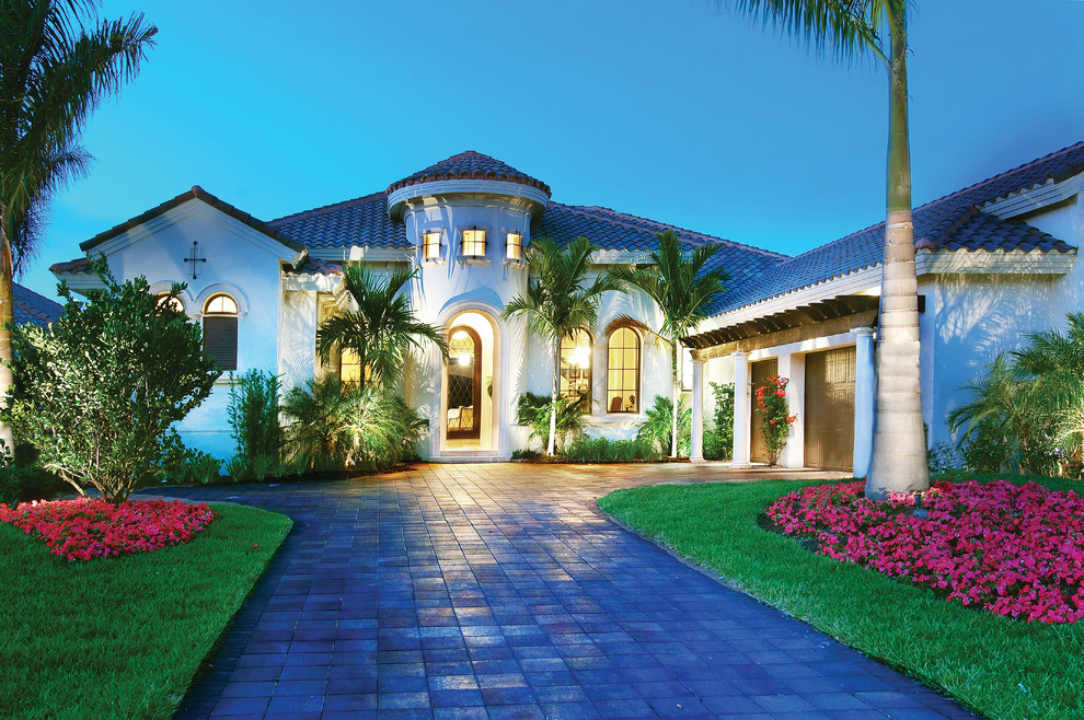 Design ideas for a large mediterranean one-storey stucco beige exterior in Miami with a hip roof.