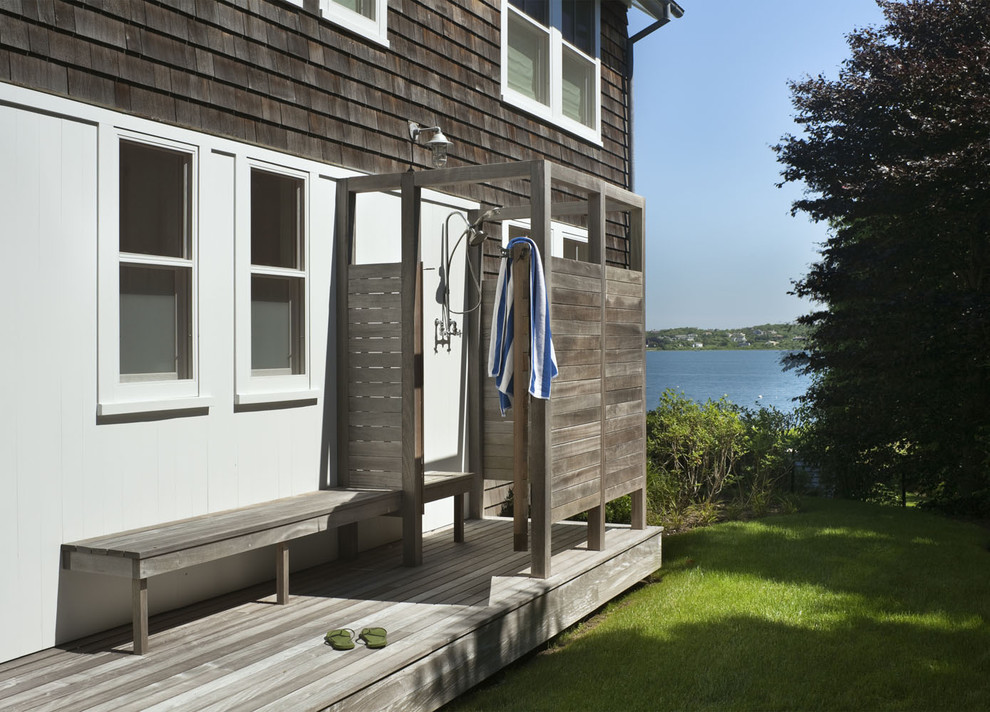 This is an example of a small beach style patio in New York with no cover and an outdoor shower.