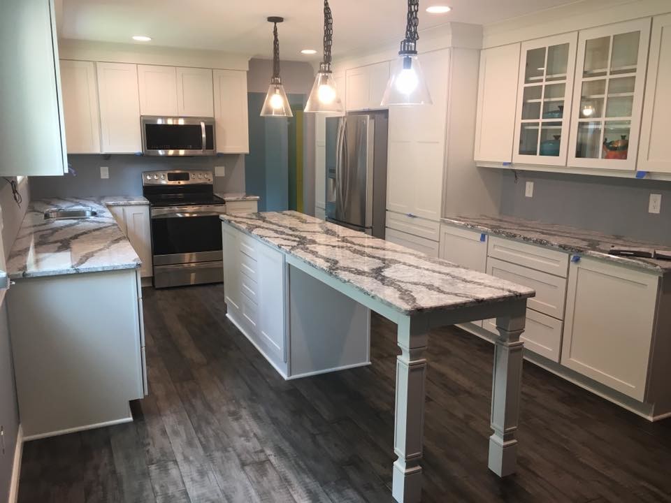 Inspiration for a mid-sized transitional galley gray floor eat-in kitchen remodel in Detroit with white cabinets, stainless steel appliances and an island