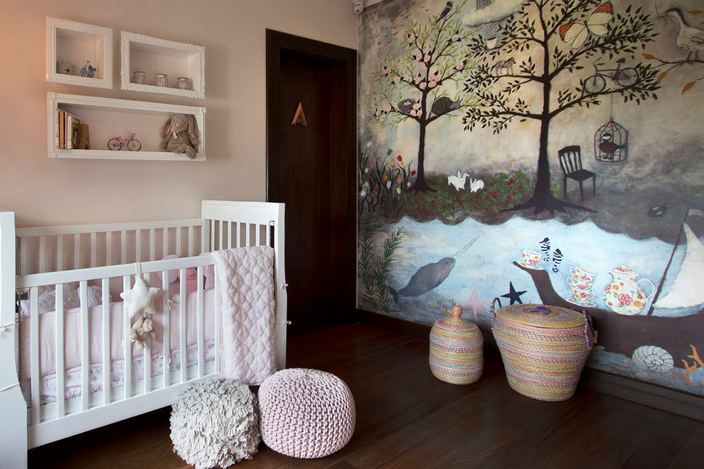 Design ideas for a small traditional nursery for girls in Other with pink walls and medium hardwood floors.