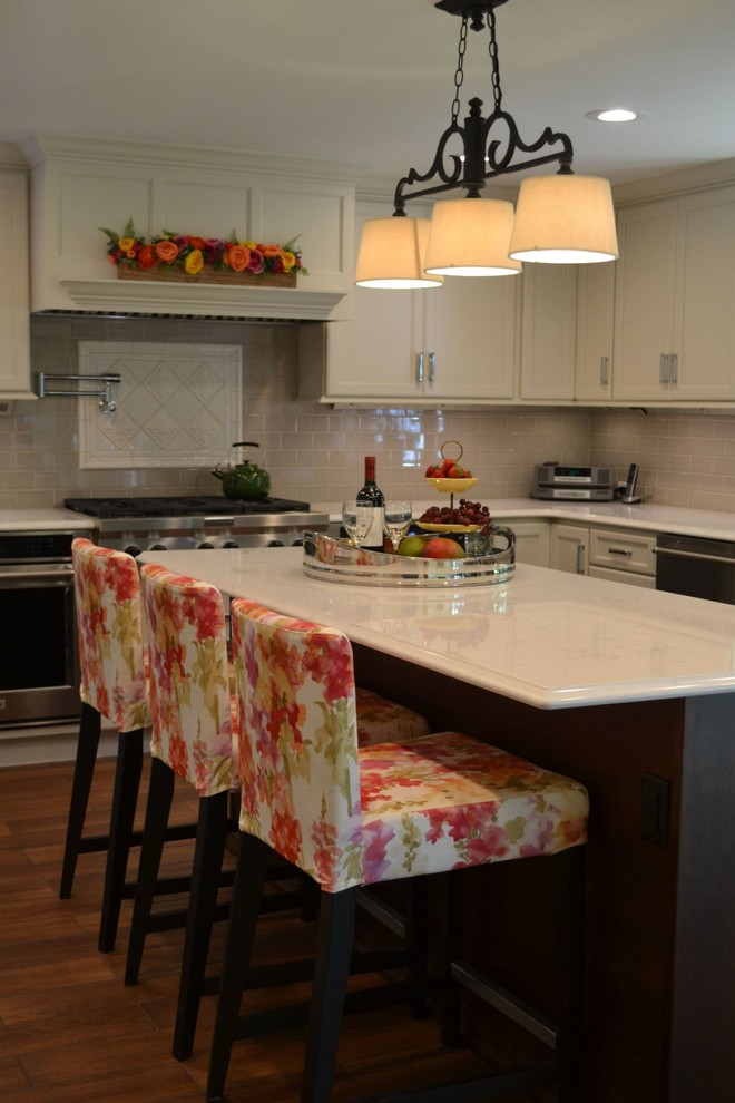 Example of a large transitional ceramic tile kitchen design with an undermount sink, recessed-panel cabinets, white cabinets, quartzite countertops, gray backsplash, subway tile backsplash, stainless steel appliances and an island