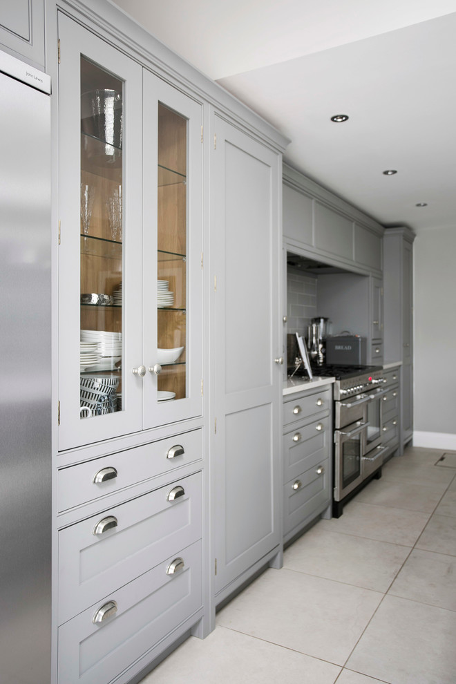 This is an example of a large contemporary single-wall open plan kitchen in Kent with a single-bowl sink, shaker cabinets, grey cabinets, quartzite benchtops, grey splashback, ceramic splashback, ceramic floors and with island.