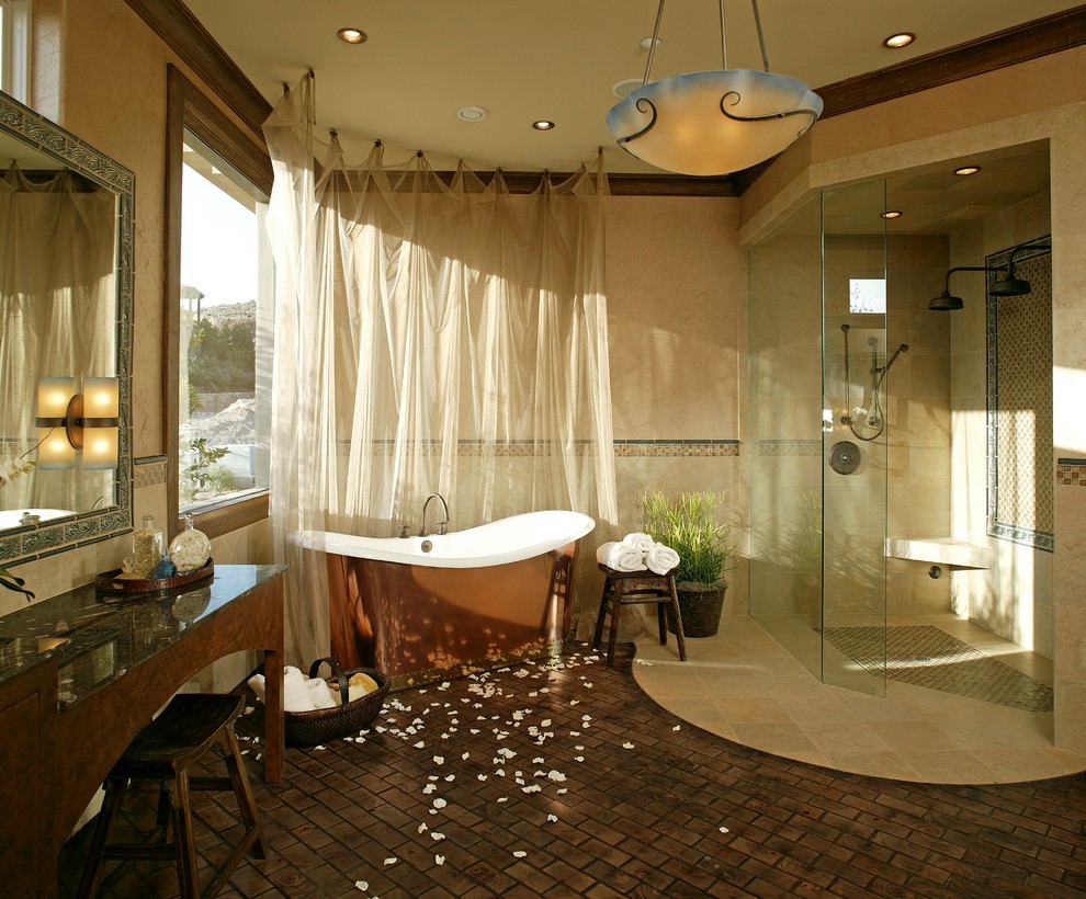 Mediterranean bathroom in Las Vegas with a curbless shower, a freestanding tub, mosaic tile and brick floors.