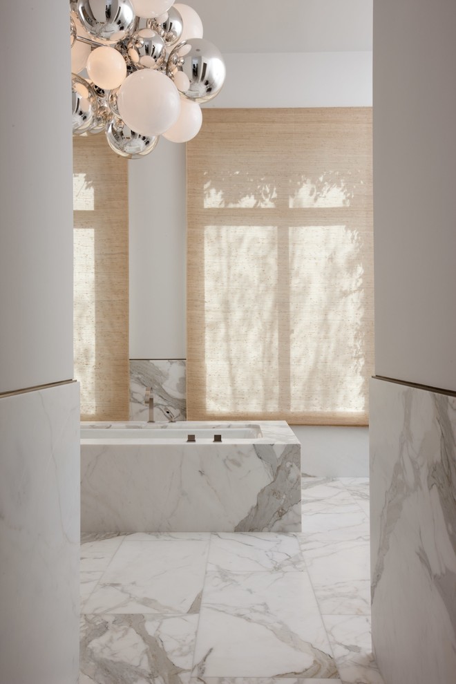 Inspiration for an expansive contemporary master bathroom in San Francisco with an undermount tub, white tile, stone slab, white walls and marble floors.