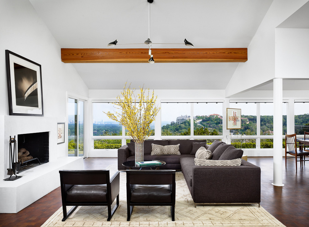 Inspiration for a contemporary open concept living room in Austin with white walls and a standard fireplace.