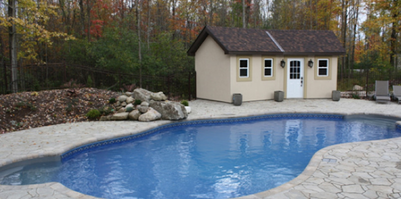 Inspiration for a mid-sized backyard concrete paver and freeform pool remodel