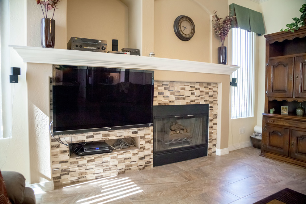 Inspiration for a transitional galley porcelain tile open concept kitchen remodel in Phoenix with an undermount sink, raised-panel cabinets, dark wood cabinets, granite countertops, beige backsplash, stone tile backsplash, stainless steel appliances and an island