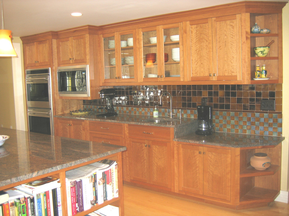 Mid-sized transitional u-shaped bamboo floor eat-in kitchen photo in Boston with an undermount sink, shaker cabinets, medium tone wood cabinets, granite countertops, multicolored backsplash, ceramic backsplash, stainless steel appliances and an island