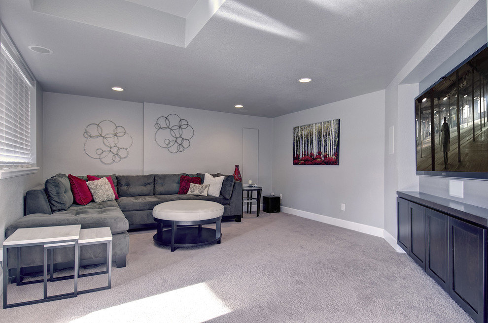 Design ideas for a mid-sized transitional look-out basement in Denver with grey walls, carpet, a ribbon fireplace, a plaster fireplace surround and brown floor.