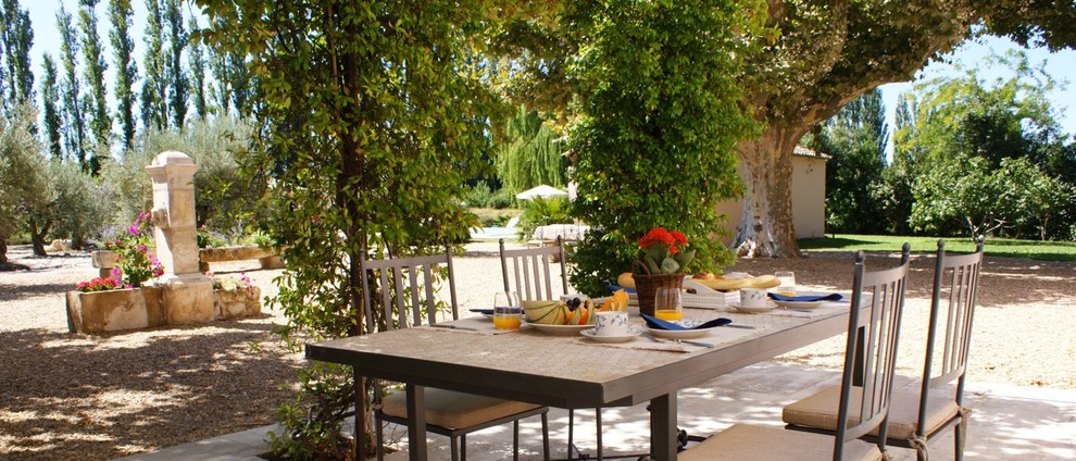 Inspiration for a mid-sized mediterranean backyard patio in Marseille with natural stone pavers and a gazebo/cabana.