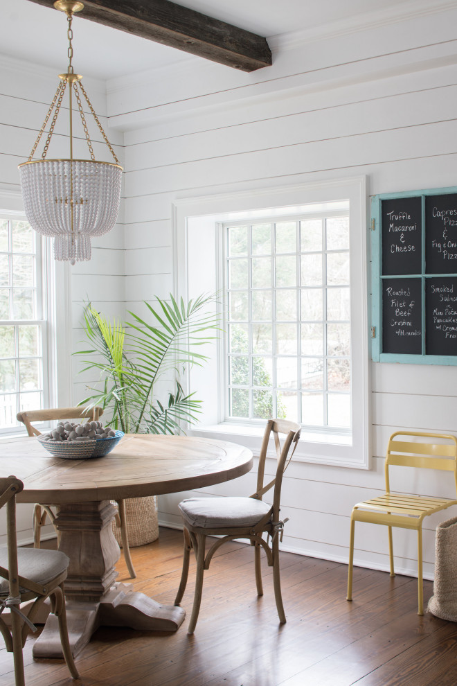 This is an example of a large nautical kitchen/dining room in Other with white walls, dark hardwood flooring, brown floors and tongue and groove walls.