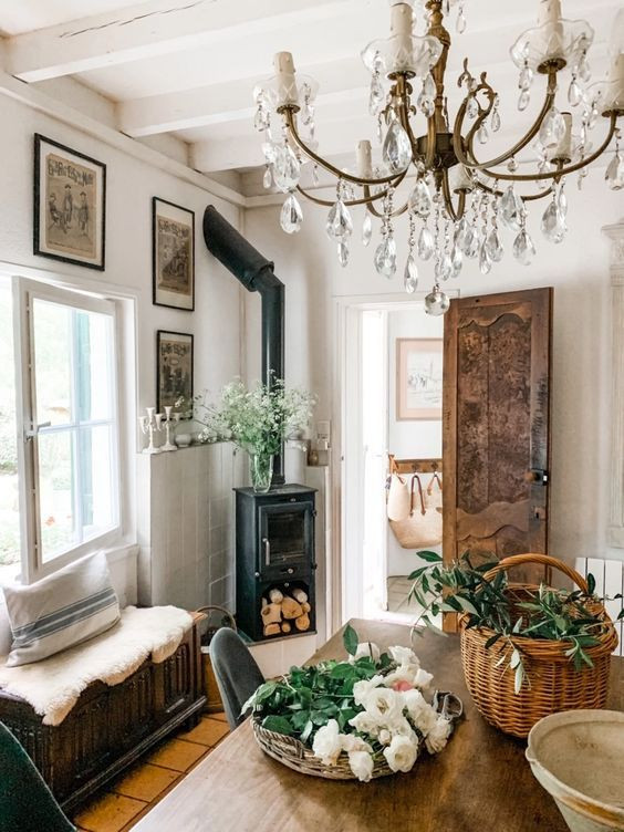 Inspiration for a mid-sized home office in Orange County with a library, white walls, light hardwood floors, a corner fireplace, a tile fireplace surround, a freestanding desk, white floor, wood and decorative wall panelling.