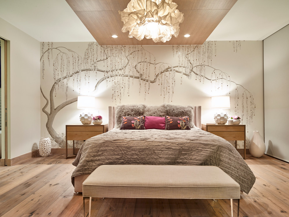 This is an example of a large contemporary guest bedroom in Denver with white walls and light hardwood floors.