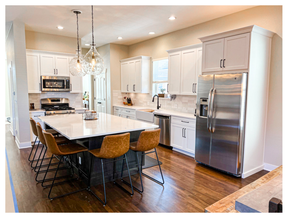 Eat-in kitchen - mid-sized transitional dark wood floor eat-in kitchen idea in Denver with a farmhouse sink, raised-panel cabinets, white cabinets, gray backsplash, stainless steel appliances, an island and white countertops