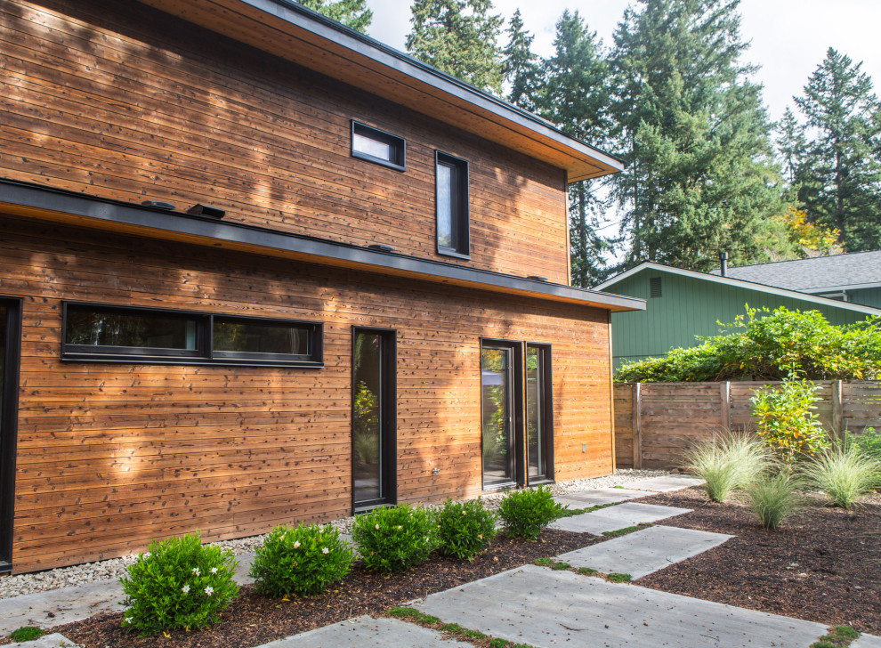 Photo of a mid-sized modern two-storey brown house exterior in Portland with wood siding.