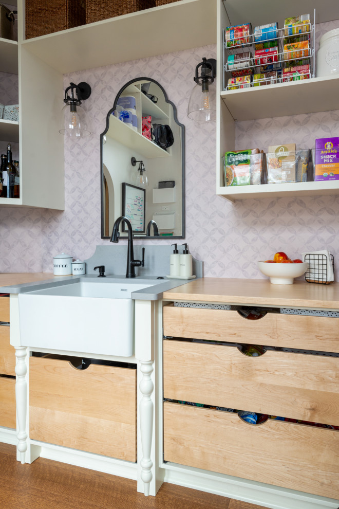 Example of a large medium tone wood floor and exposed beam eat-in kitchen design with white backsplash, stainless steel appliances and an island