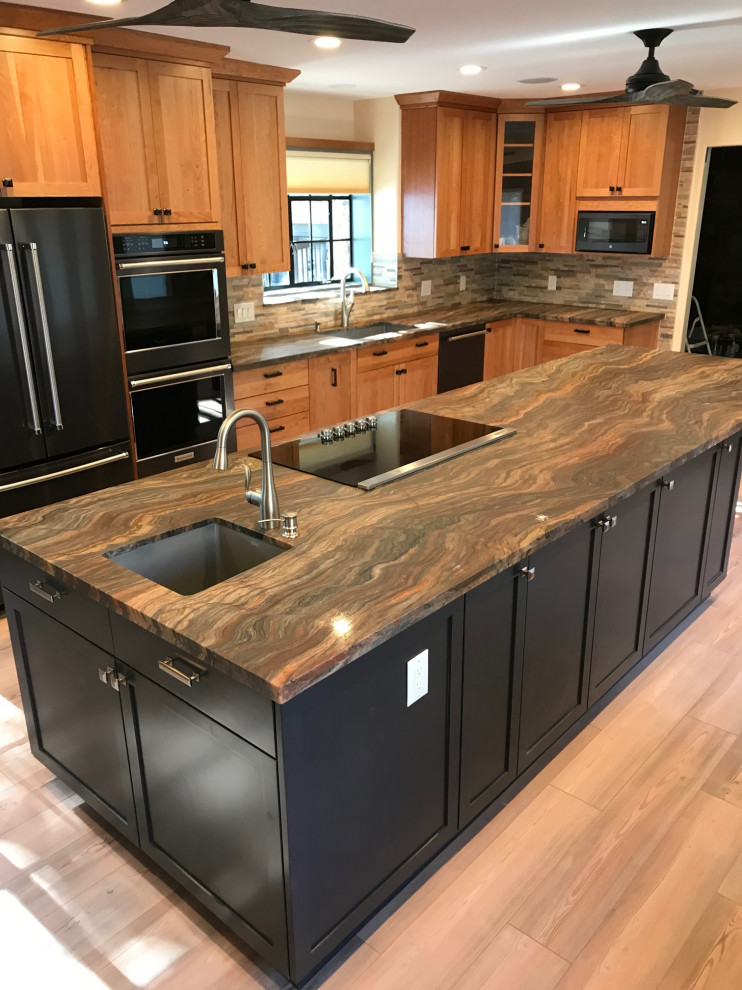 Eat-in kitchen - mid-sized rustic l-shaped eat-in kitchen idea with shaker cabinets, black cabinets, granite countertops and an island