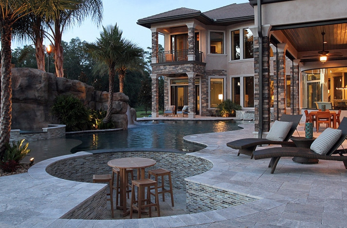 Inspiration for a transitional backyard stone and custom-shaped pool remodel in Jacksonville