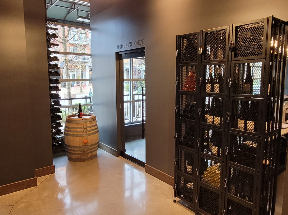 Large contemporary wine cellar in Seattle with concrete floors, storage racks and beige floor.