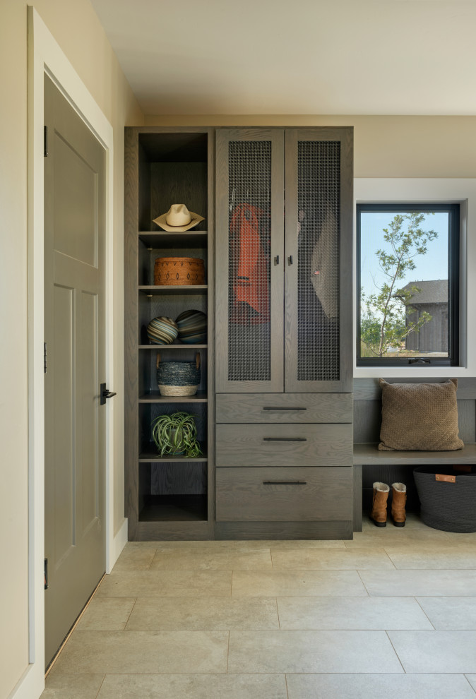 This is an example of a traditional utility room in Other with flat-panel cabinets and grey cabinets.