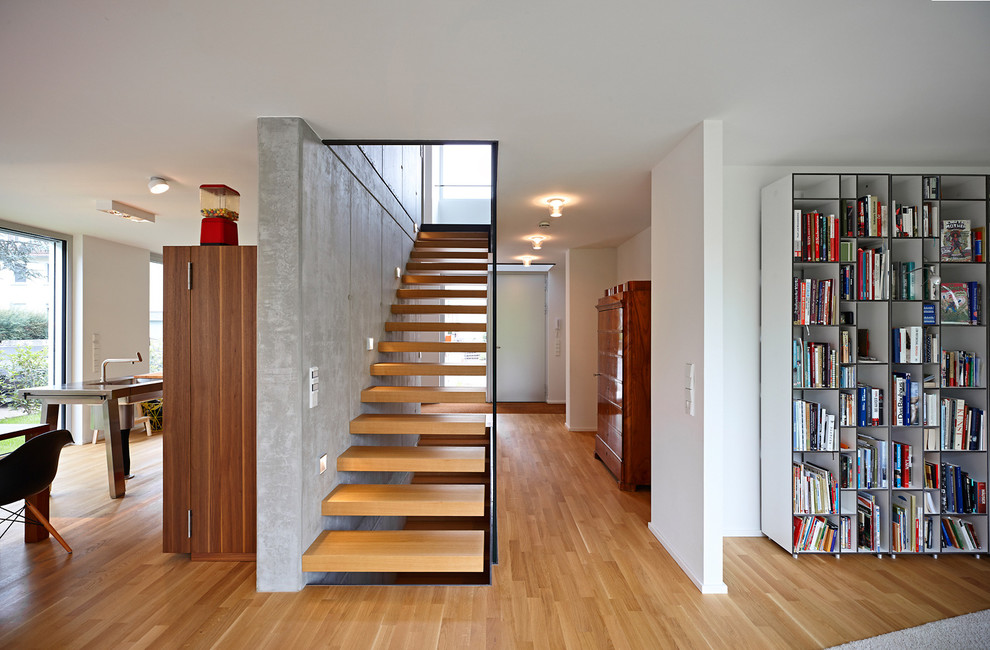 This is an example of a mid-sized contemporary wood straight staircase in Frankfurt with open risers.