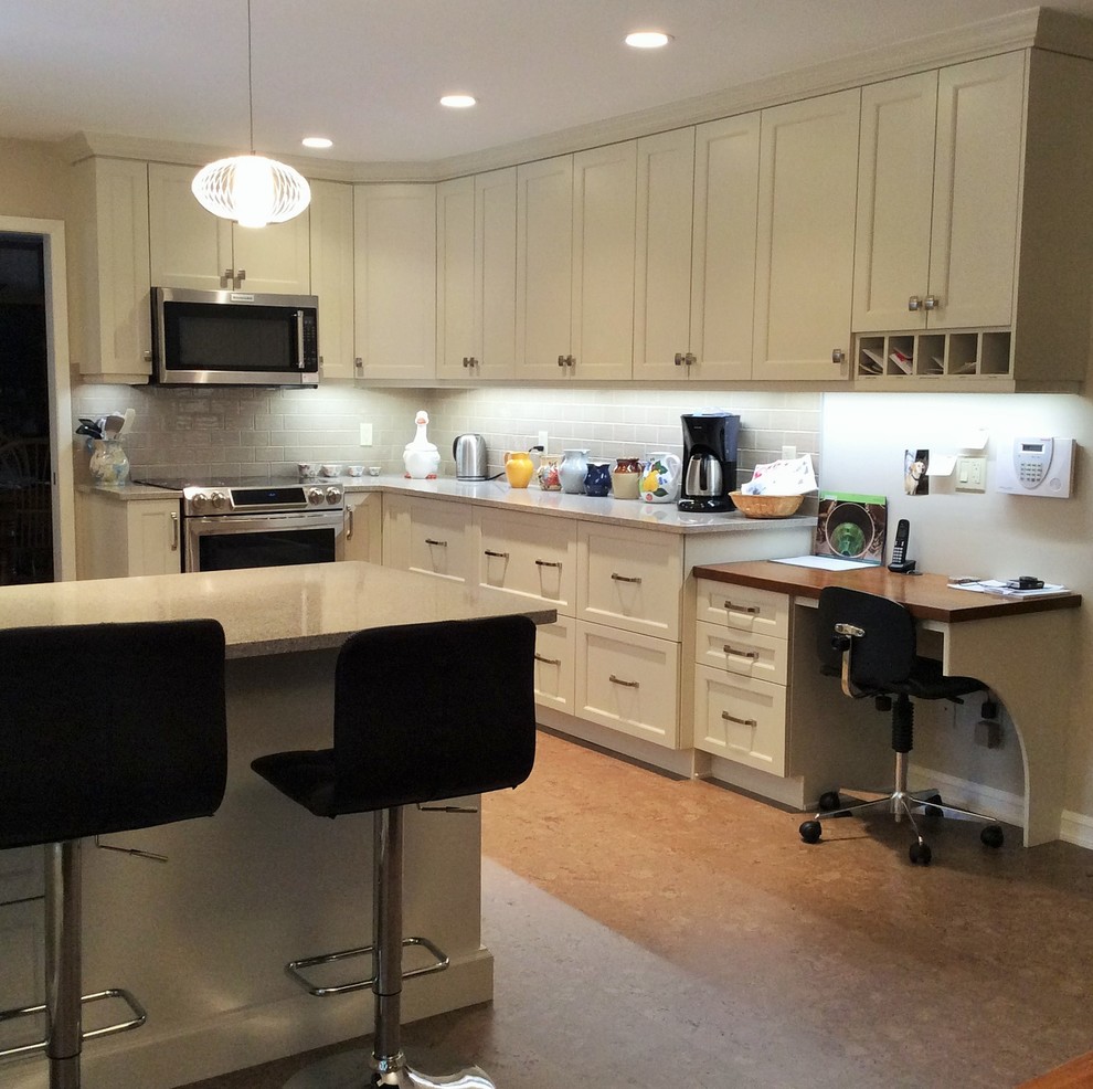 Kitchen - transitional cork floor kitchen idea in Edmonton with white cabinets, quartzite countertops, gray backsplash, ceramic backsplash and stainless steel appliances