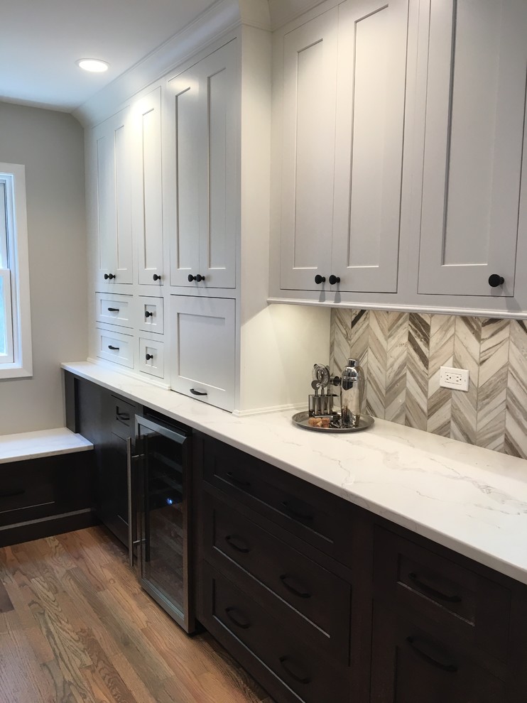 Small transitional medium tone wood floor and brown floor eat-in kitchen photo in Chicago with a farmhouse sink, shaker cabinets, gray cabinets, quartzite countertops, gray backsplash, stone tile backsplash, stainless steel appliances, no island and white countertops