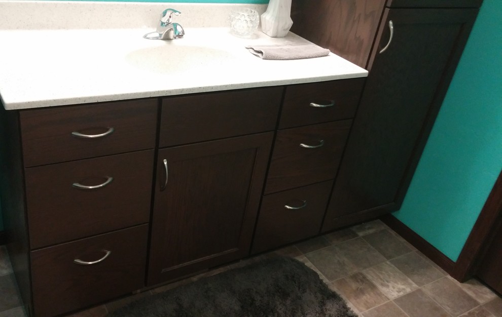 Transitional master home design photo with shaker cabinets, blue walls and an integrated sink