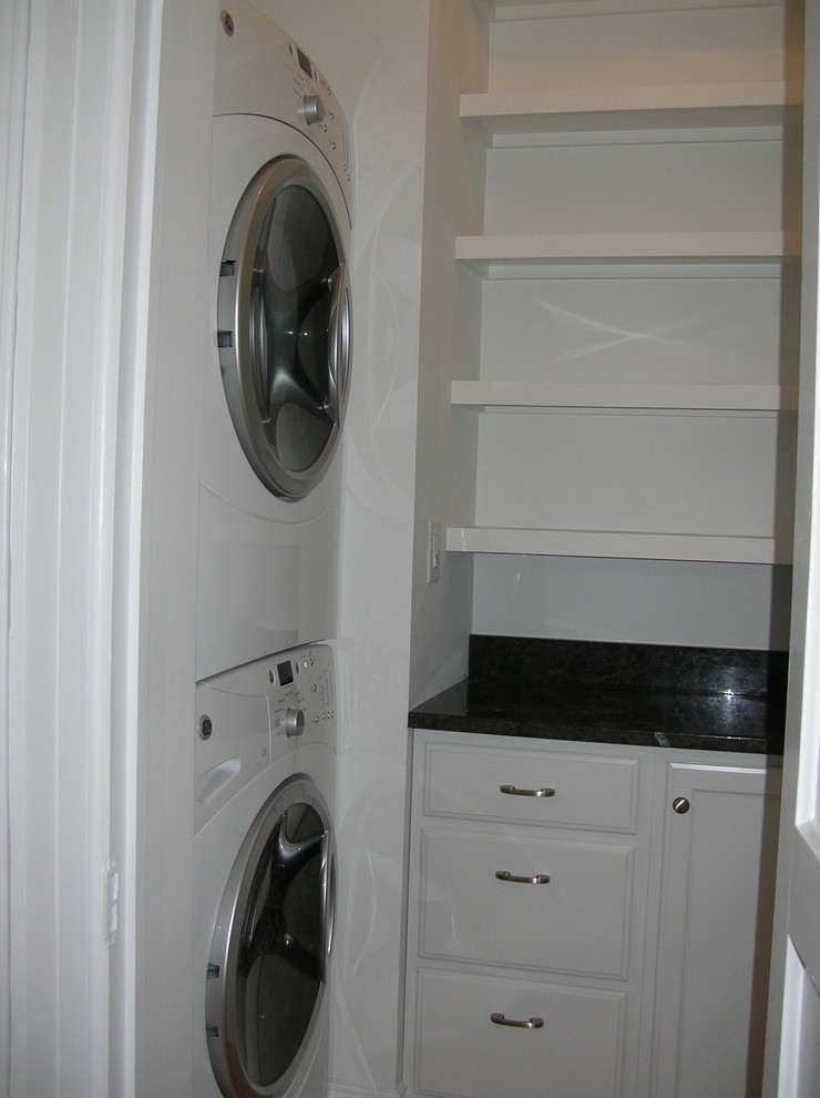 Photo of a large traditional laundry room in Boston with dark hardwood floors.