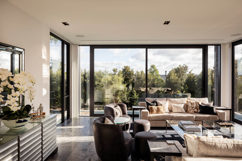 Inspiration for a Large contemporary Formal Enclosed living room in Auckland With White Walls, Marble Floors, a Standard Fireplace, a Stone Fireplace Surround, a Wall-mounted TV, Grey Floor and Wood.