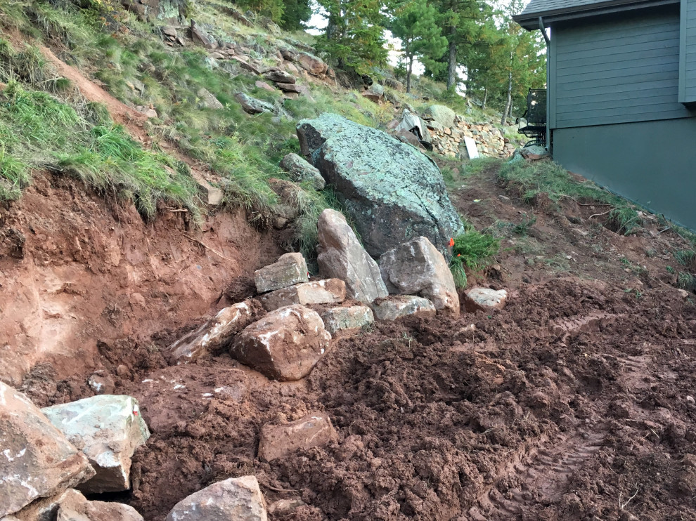 This is an example of a huge rustic hillside retaining wall landscape in Denver.