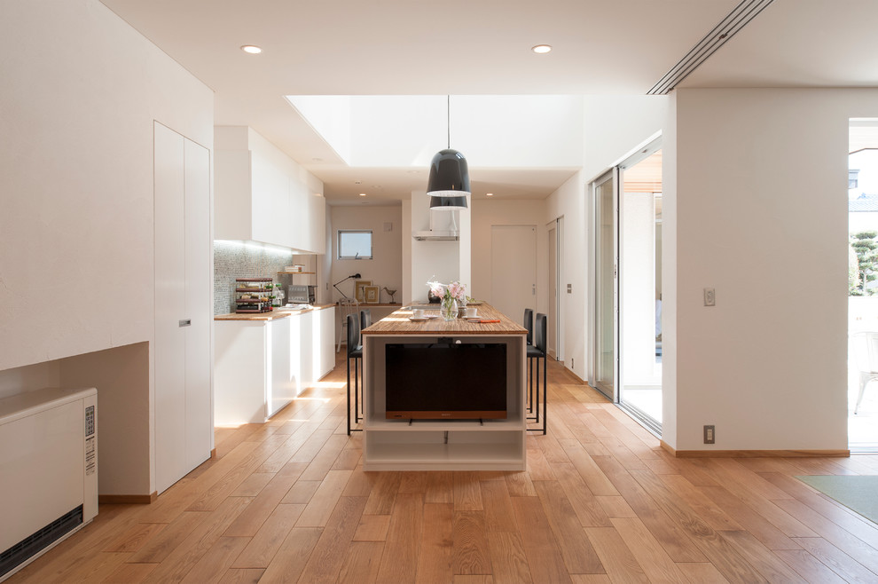 Photo of a contemporary open plan dining in Other with white walls and medium hardwood floors.