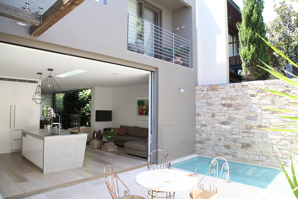 This is an example of a modern courtyard pool in Sydney with tile.