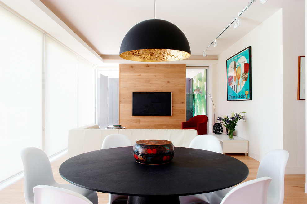 This is an example of a large contemporary dining room in Melbourne with white walls and light hardwood floors.