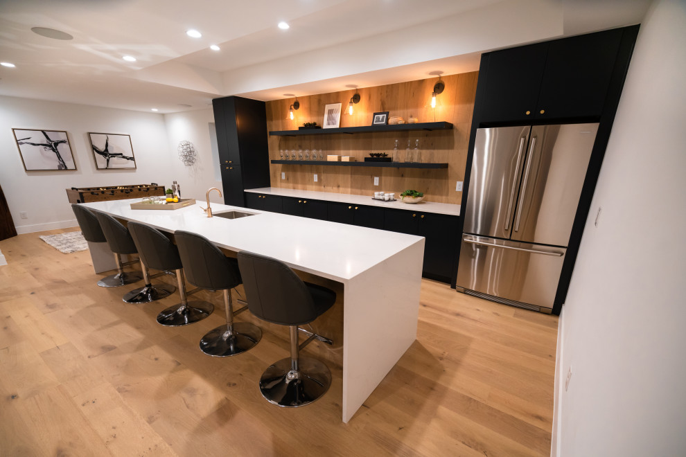 This is an example of a mid-sized modern galley wet bar in Denver with an undermount sink, flat-panel cabinets, black cabinets, quartzite benchtops, brown splashback, timber splashback and white benchtop.