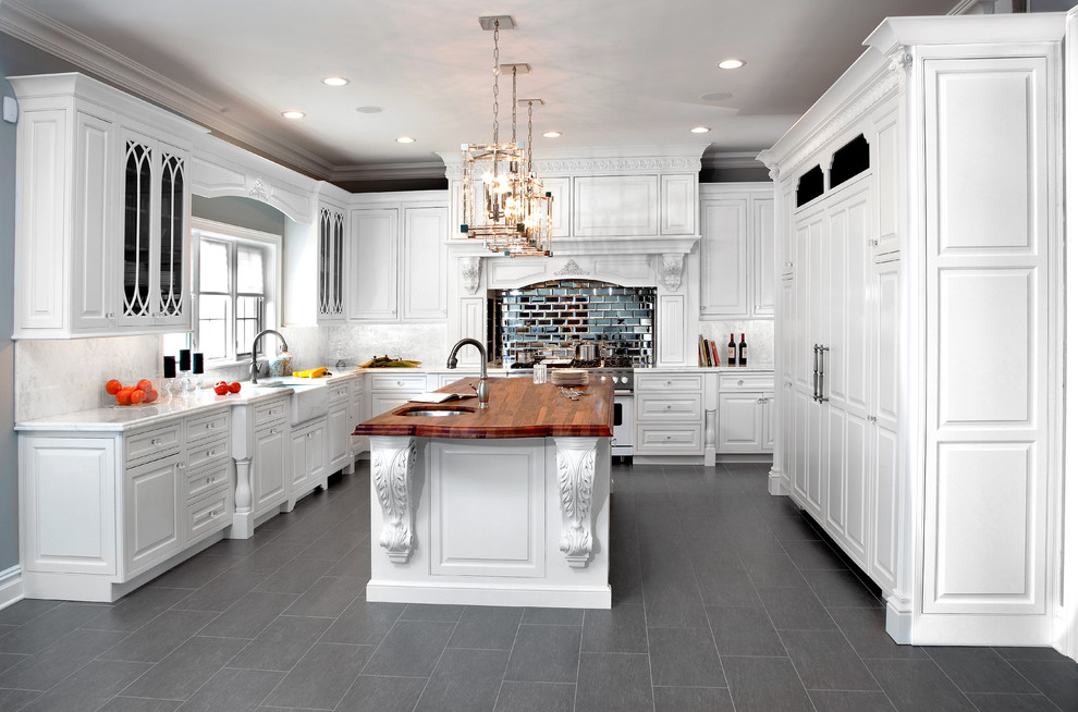 Large traditional u-shaped eat-in kitchen in New York with a farmhouse sink, beaded inset cabinets, white cabinets, white splashback, stone tile splashback, panelled appliances, marble benchtops, porcelain floors and with island.