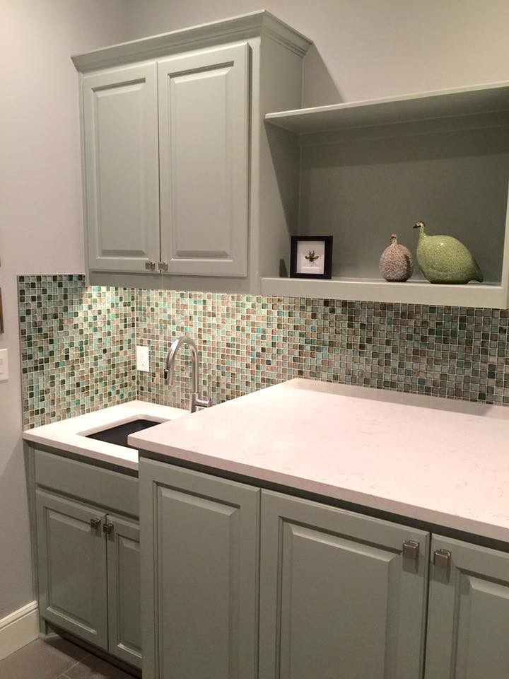 Example of a mid-sized transitional single-wall laundry room design in Austin with an undermount sink, green cabinets and gray walls